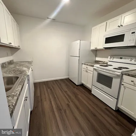 a kitchen with a stove microwave and sink