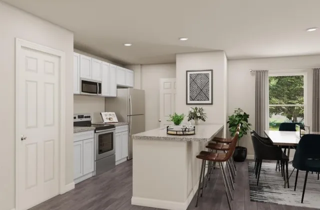 a kitchen with sink cabinets and dining table chair