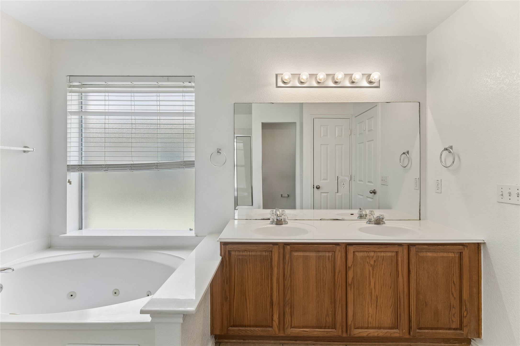 2372 Paradise Ridge Drive Round Rock, TX 78665 - Photo 21 of 40 Double vanities and a relaxing soaking tub create a luxurious primary bathroom retreat.