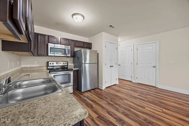 a kitchen with a refrigerator sink and stove