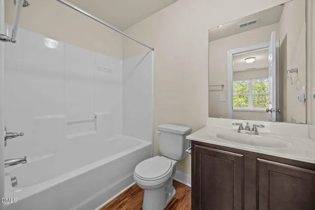a bathroom with a sink toilet vanity and shower