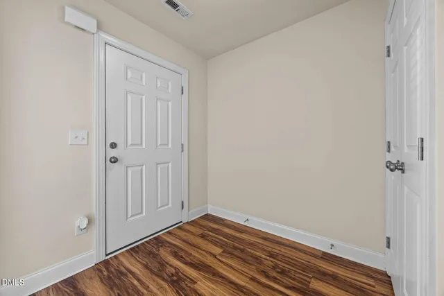 a view of a room with wooden floor