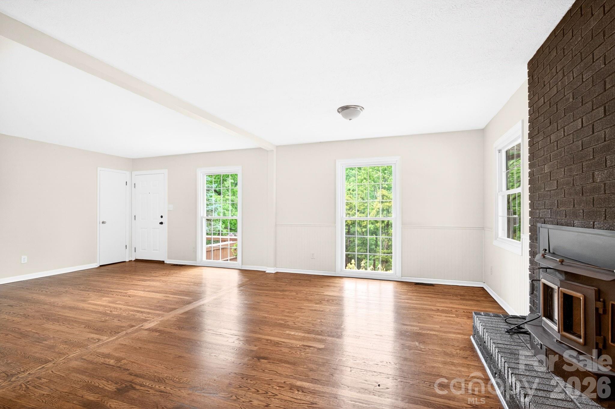 34 Wolfe Cove Road Asheville, NC 28804 - Photo 7 of 42 an empty room with wooden floor and windows