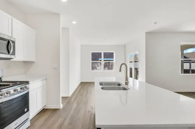 a view of kitchen with furniture and wooden floor