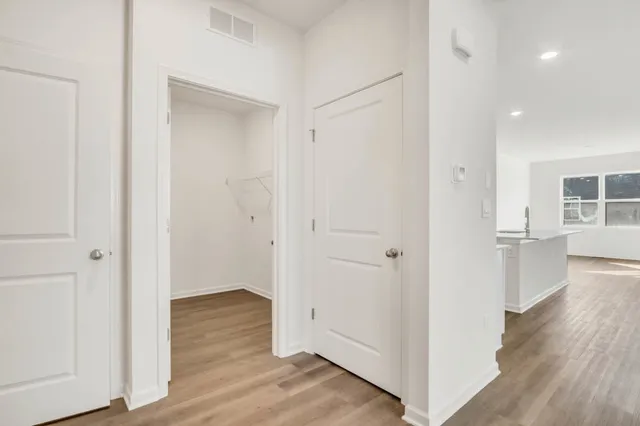 a view of a hallway with wooden floor