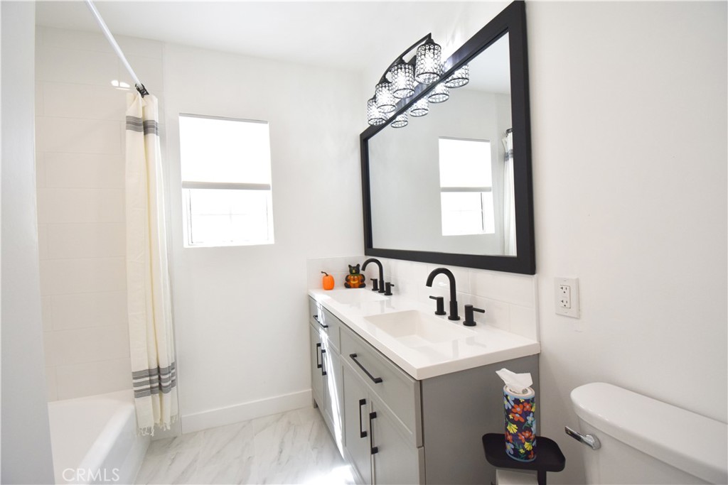 1570 North Verdugo Road, Unit B Glendale, CA 91208 - Photo 11 of 12 a bathroom with a sink mirror vanity and toilet
