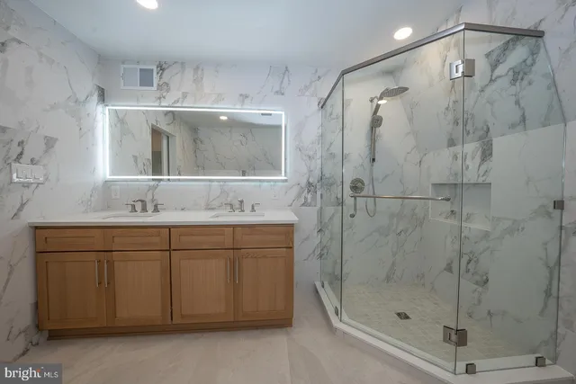 a bathroom with a shower sink and mirror