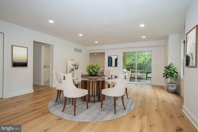 a view of a dining room with furniture window and wooden floor
