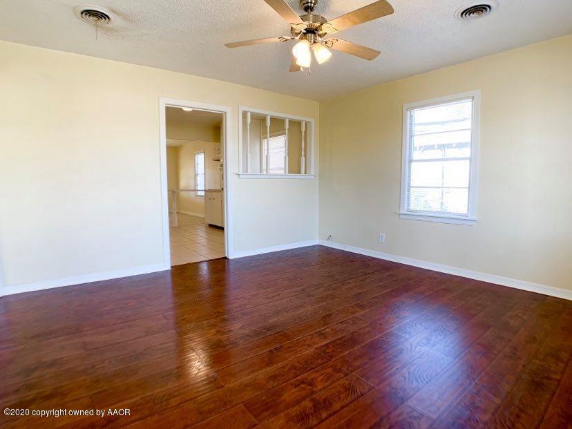 4124 South Jackson Street Amarillo, TX 79110 - Photo 1 of 13 a view of an empty room with wooden floor and a window