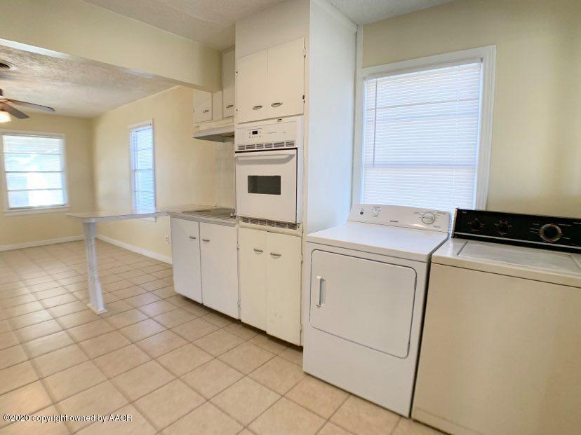 4124 South Jackson Street Amarillo, TX 79110 - Photo 4 of 13 a utility room with cabinets washer and dryer