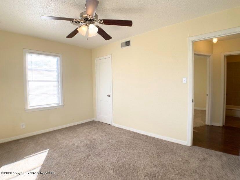 4124 South Jackson Street Amarillo, TX 79110 - Photo 8 of 13 a view of a room with a ceiling fan and a window