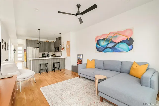 a living room with furniture and a kitchen view