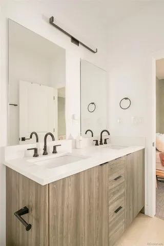 a bathroom with a double vanity sink and a mirror