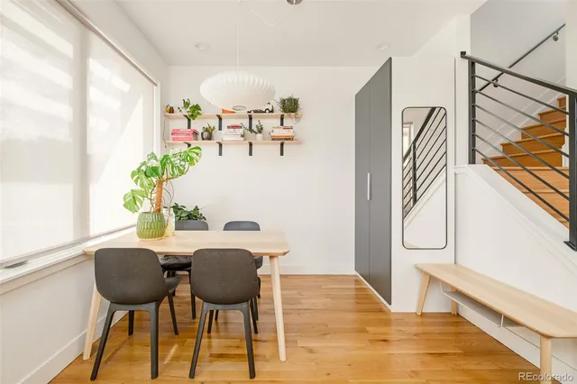 a view of a dining room with furniture and a potted plant