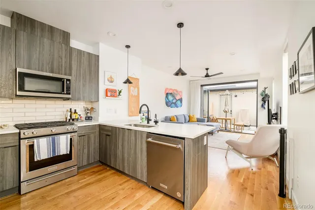 a kitchen with stainless steel appliances granite countertop a sink and stove top oven