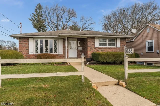 a front view of a house with a garden and porch