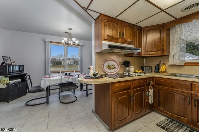 a kitchen with a stove a sink and cabinets