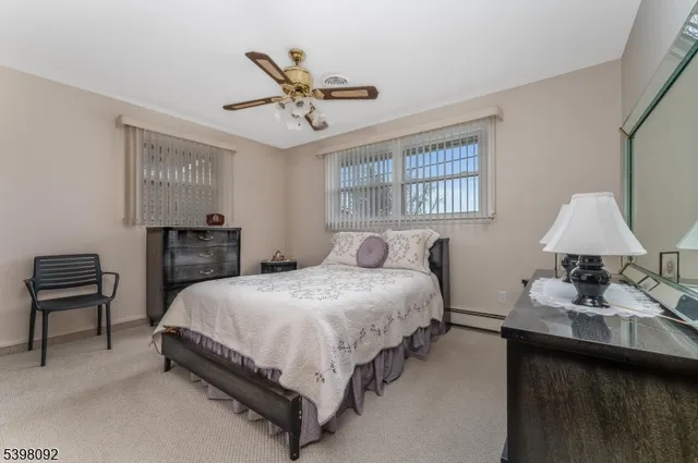 a bedroom with a bed a lamp and a large mirror