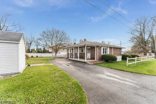 a front view of a house with patio and garden