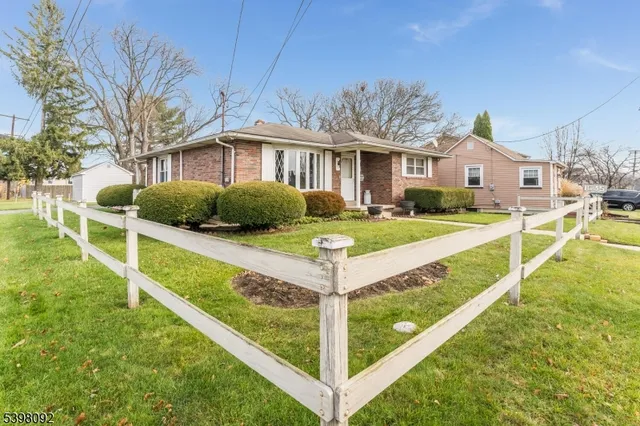 a front view of a house with a yard table and chairs