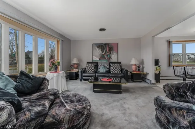 a bedroom with furniture and a large window