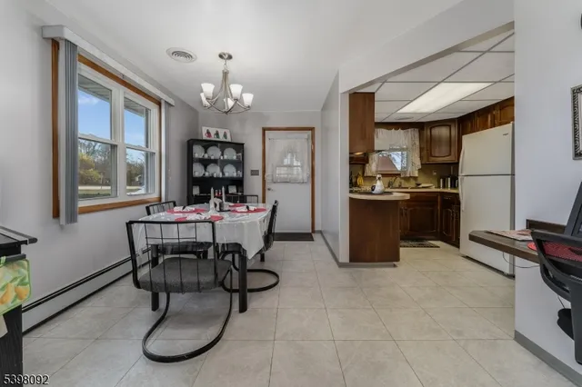 a dining room with furniture and window