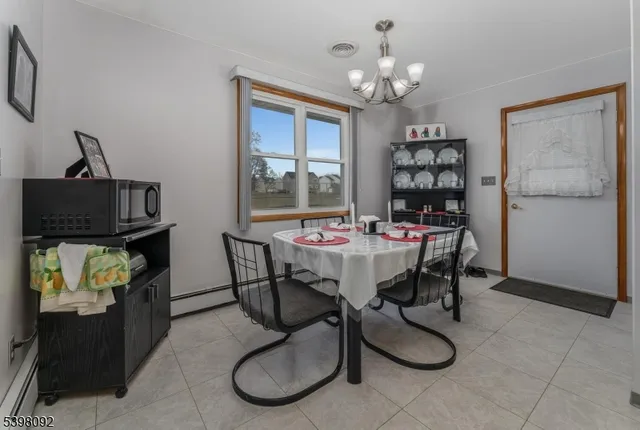 a view of a dining room with furniture and chandelier