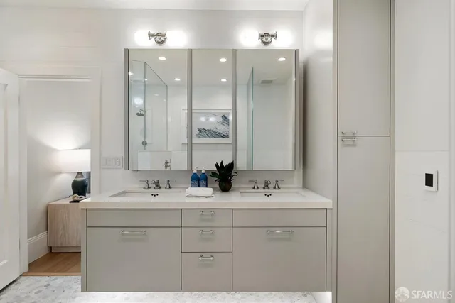 a bathroom with a sink vanity and mirror