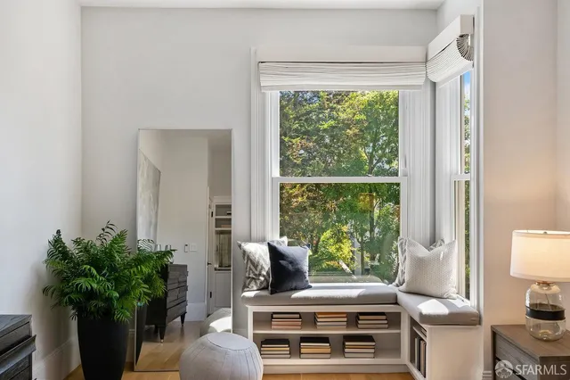 a living room with furniture and a potted plant