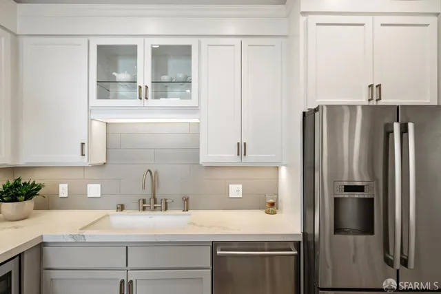 a kitchen with a sink and refrigerator