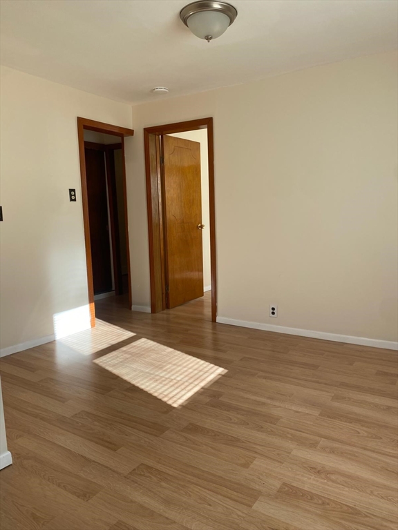 38 Chapel Street, Unit 1 Lowell, MA 01852 - Photo 15 of 18 a view of an empty room with wooden floor