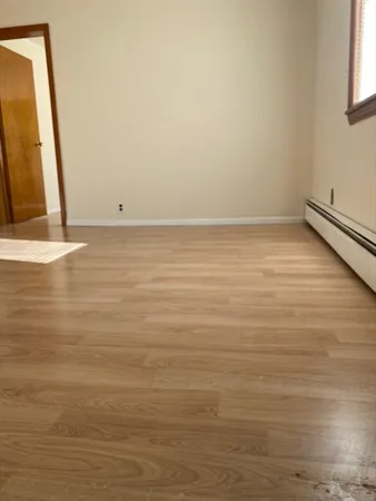a view of a room with wooden floor