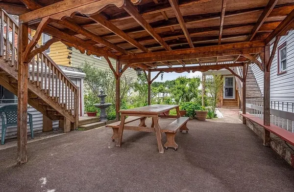 a view of a patio with table and chairs