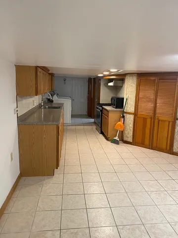 a room with a washing machine and a sink