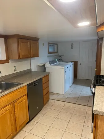 a kitchen with a sink cabinets and appliances