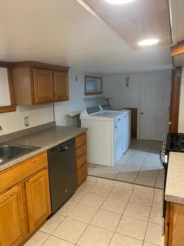 a kitchen with a sink cabinets and appliances