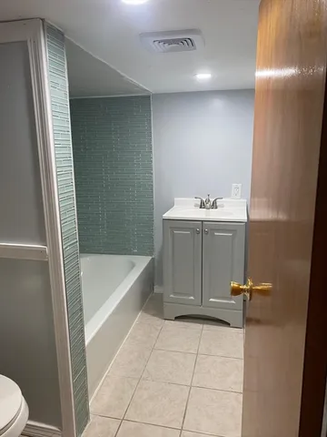 a bathroom with a sink a toilet and bathtub