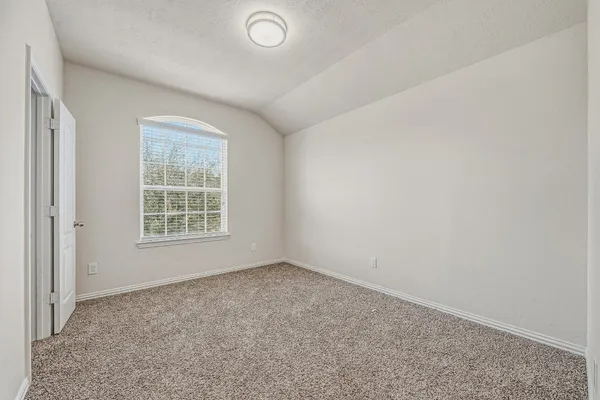 a bedroom with a flat screen television and a bed