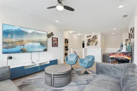 a bedroom with a large bed and a chandelier