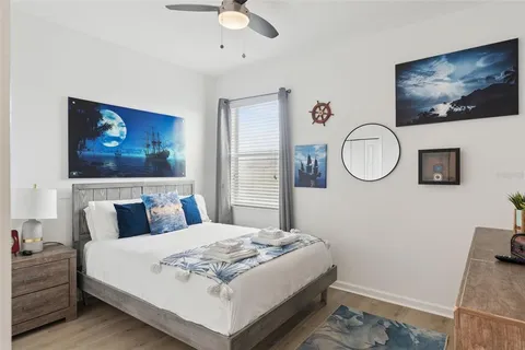 a bedroom with a bed a dresser next to a window