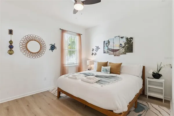 a bedroom with a bed and wooden floor