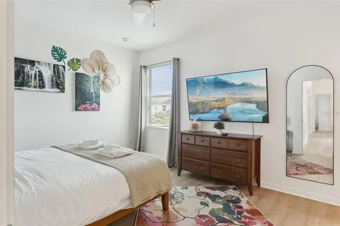 a bedroom with a bed and a flat screen tv