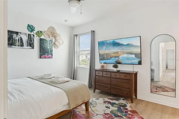 a bedroom with a bed and a flat screen tv