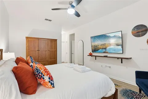 a bedroom with a bed and wooden floor