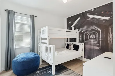 a view of a bedroom with furniture and window