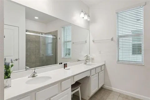 a living room with furniture a flat screen tv and a floor to ceiling window
