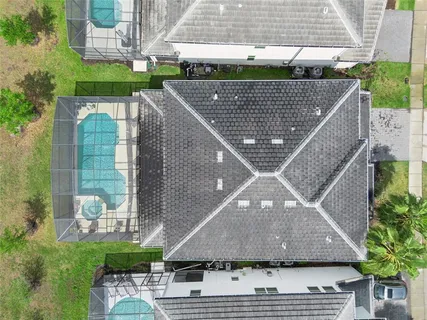a front view of a house with garden and houses