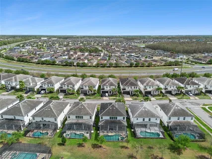 a view of a swimming pool with a lounge chair and palm trees