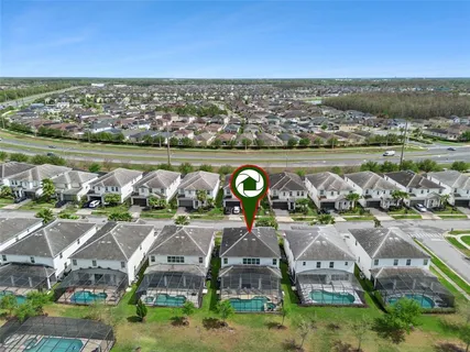 a swimming pool with outdoor seating and palm tree