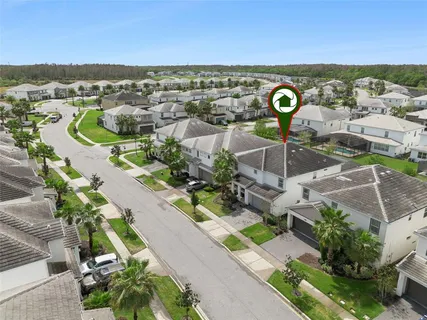 an aerial view of residential houses with outdoor space and swimming pool